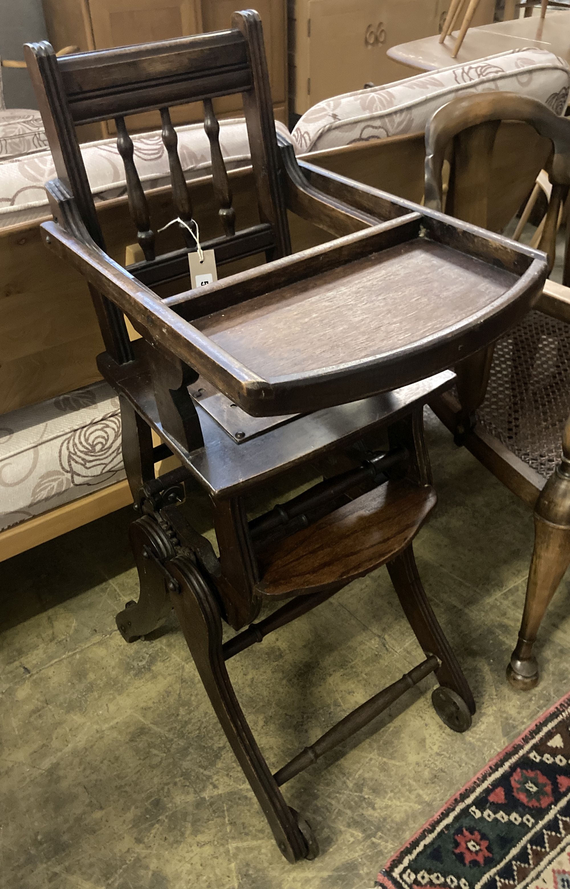 An early 20th century oak and beech childs metamorphic high chair